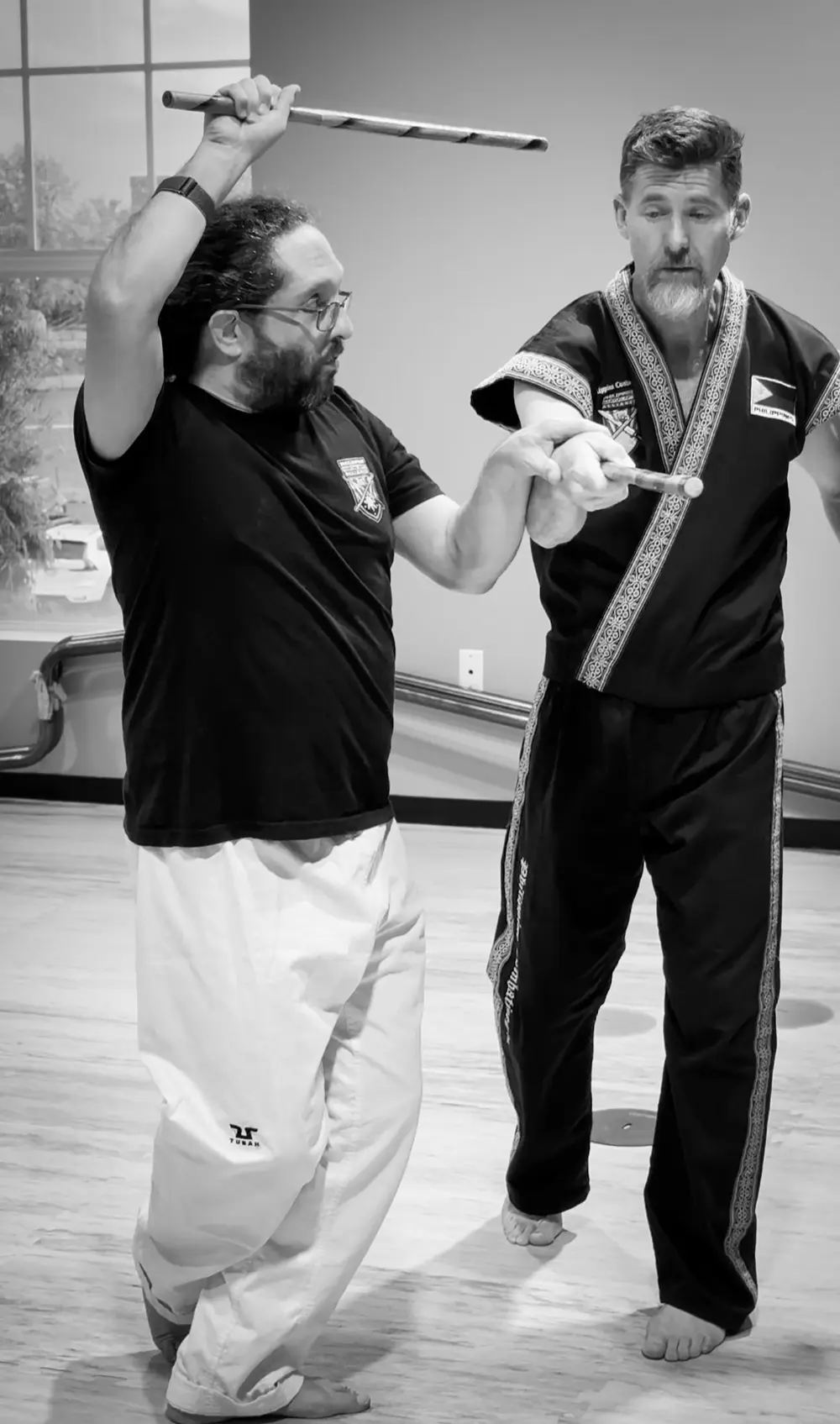 Adults practicing Philippine Combatives stick techniques at King Tiger Harrisburg